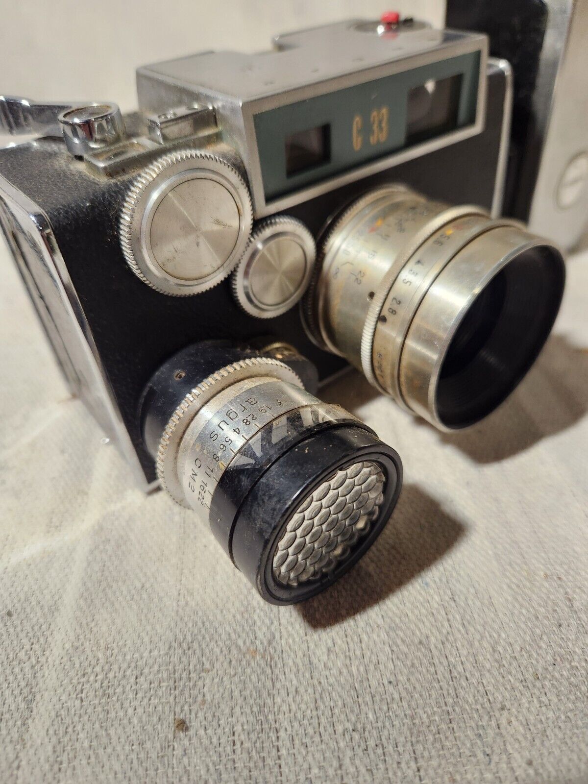 Vintage Argus C-33 Camera with flash attachment and documents